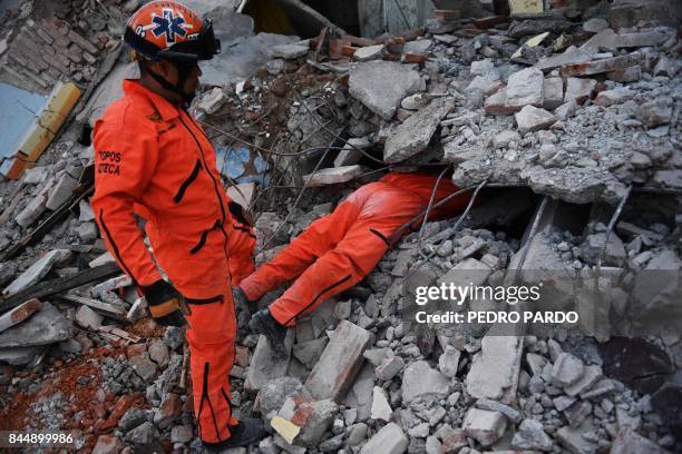 Member of the "Topos" specialized rescue team search for survivors in Juchitan de Zaragoza, Mexico, on September 9, 2017 after a powerful earthquake...
