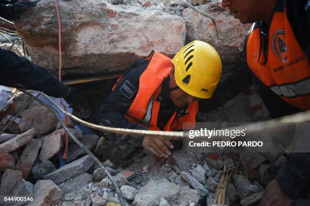 Members of the Federal Police's rescue team search for survivors in Juchitan de Zaragoza, Mexico, on September 9, 2017 after a powerful earthquake...