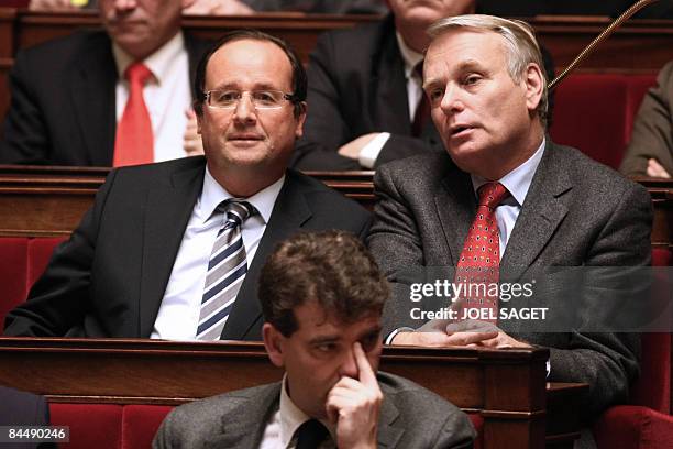 Head of French socialist party group at the national Assembly Jean-Marc Ayrault speaks with former PS first secretary Francois Hollande next to...