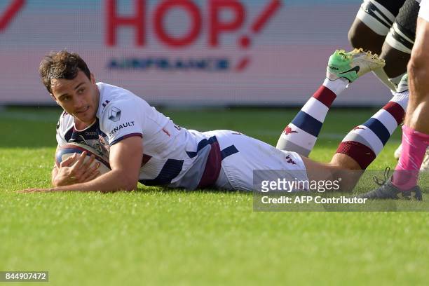 Bordeaux-Begles' French fullback Nans Ducuing scores a try during the French Top 14 rugby union match between Bordeaux-Begles and Stade Francais on...