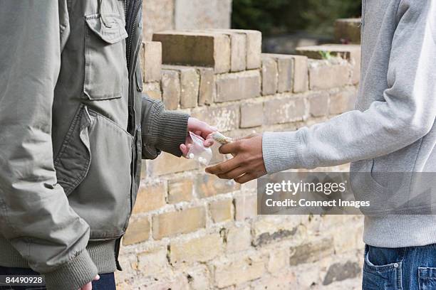 teenagers passing drugs - crime or recreational drug or prison or legal trial stock pictures, royalty-free photos & images