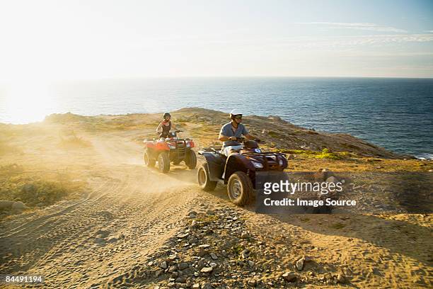 people riding all terrain vehicles - cabo san lucas stockfoto's en -beelden