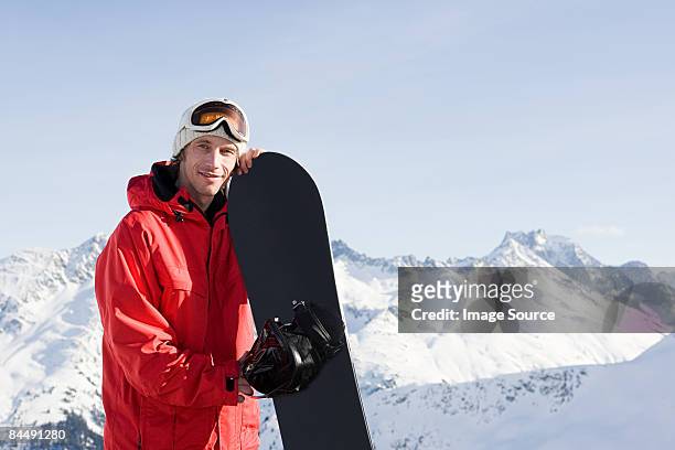 portrait of a man holding a snowboard - snowboard foto e immagini stock