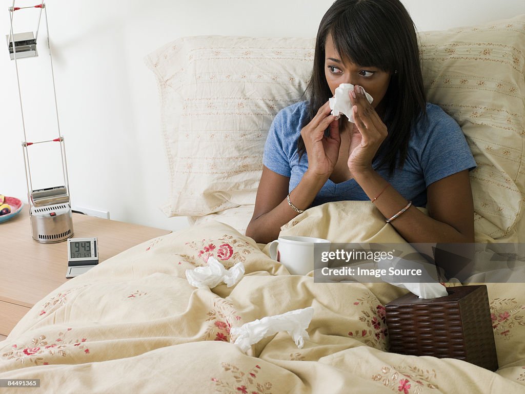 Woman in bed with cold