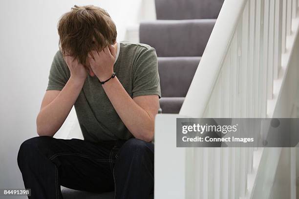 a teenage boy crying - boy stairs stock pictures, royalty-free photos & images