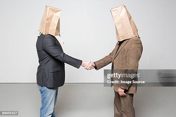 men with paper bags on their heads - awkward handshake stock pictures, royalty-free photos & images