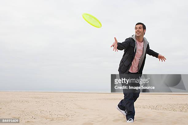 man throwing a flying disc - throwing stock pictures, royalty-free photos & images