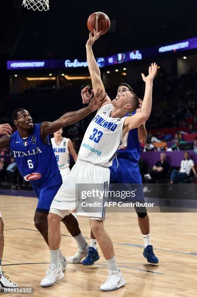 Finland's forward Erik Murphy vies for the ball with Italy's Luigi Datome and Paul Biligha during their FIBA Eurobasket 2017 men's round 16...