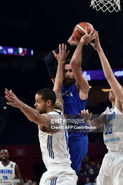 Italy's forward Luigi Datome vies for the ball with Finland's forward Gerald Lee and Erik Murphy during their FIBA Eurobasket 2017 men's round 16...