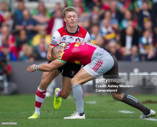 Gloucester Rugby's Ollie Thorley is tackled by Harlequins' Mike Brown during the Aviva Premiership match between Harlequins and Gloucester Rugby at...