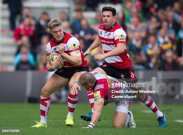 Gloucester Rugby's Ollie Thorley evades the tackle of Harlequins' Mike Brown during the Aviva Premiership match between Harlequins and Gloucester...
