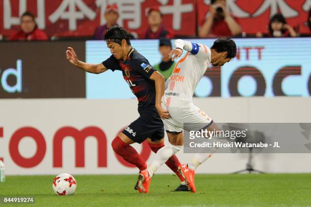 Mu Kanazaki of Kashima Antlers goes past Kosuke Kikuchi of Omiya Ardija during the J.League J1 match between Kashima Antlers and Omiya Ardija at...