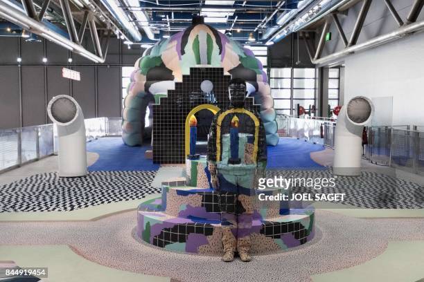 Chinese artist Liu Bolin takes part in a performance with a "Galerie Party" set, created by designers Gaelle Gabillet et Stephane Villard, during an...