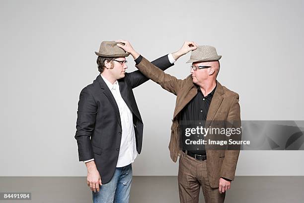 men holding hats - austauschen stock-fotos und bilder