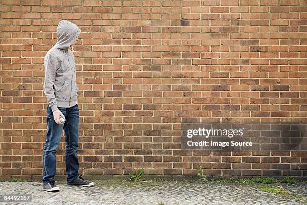 boy by wall with spray can - kriminell bildbanksfoton och bilder