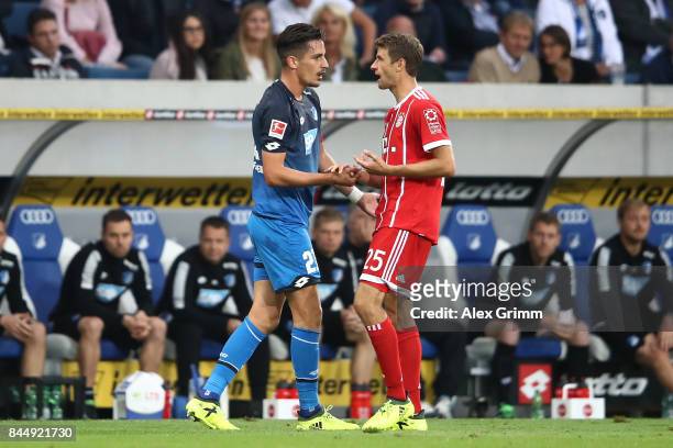 Benjamin Huebner of Hoffenheim talks with Thomas Mueller of Bayern Muenchen during the Bundesliga match between TSG 1899 Hoffenheim and FC Bayern...