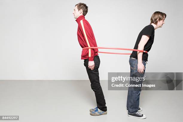 men pulling plastic hoop - stretched plastic stock pictures, royalty-free photos & images