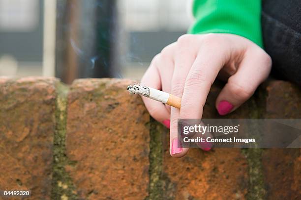 hand of a girl with cigarette - smoke stock pictures, royalty-free photos & images