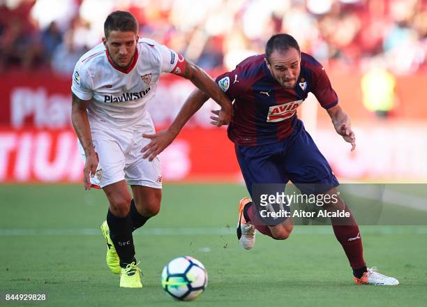 Daniel Carrico of Sevilla FC competes for the ball with Enrique Garcia of SD Eibar during the La Liga match between Sevilla and Eibar at Estadio...