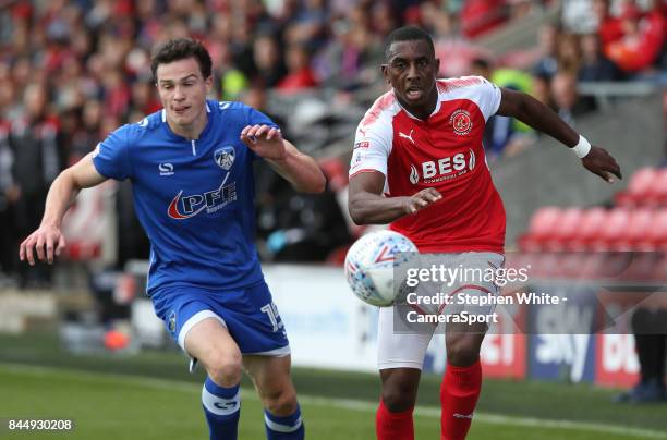 Fleetwood Town's Amari'i Bell and Oldham Athletic's George Edmundson chase the ball during the Sky Bet League One match between Fleetwood Town and...