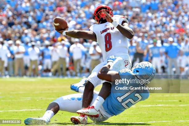 Tomon Fox of the North Carolina Tar Heels pressures Lamar Jackson of the Louisville Cardinals during the game at Kenan Stadium on September 9, 2017...