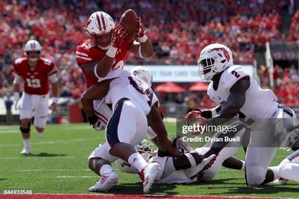 Hosea Barnwell, V of the Florida Atlantic Owls tackles Jonathan Taylor of the Wisconsin Badgers short of the goal line in the second quarter at Camp...