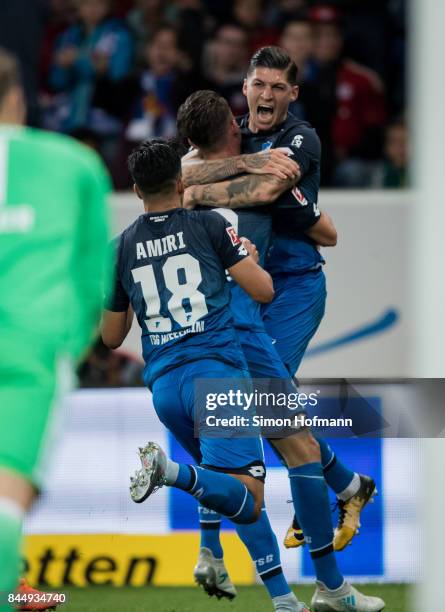 Mark Uth of Hoffenheim celebrates his team's second goal with team mate Steven Zuber during the Bundesliga match between TSG 1899 Hoffenheim and FC...