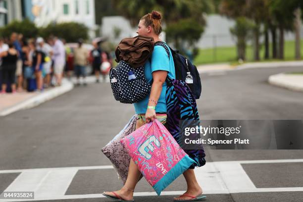 People arrive at a shelter at Alico Arena where thousands of Floridians are hoping to ride out Hurricane Irma on September 9, 2017 in Fort Myers,...