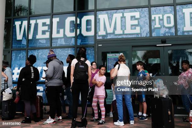 People arrive at a shelter at Alico Arena where thousands of Floridians are hoping to ride out Hurricane Irma on September 9, 2017 in Fort Myers,...