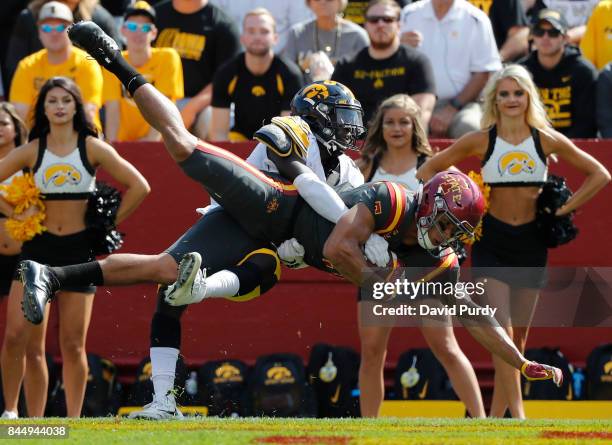 Wide receiver Allen Lazard of the Iowa State Cyclones pulls in a touchdown pass as defensive back Manny Rugamba of the Iowa Hawkeyes defends in the...