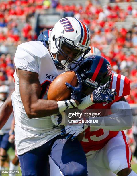 Running back Kylan Watkins of the Tennessee Martin Skyhawks catches a pass and is tackled by defensive back Myles Hartsfield of the Mississippi...