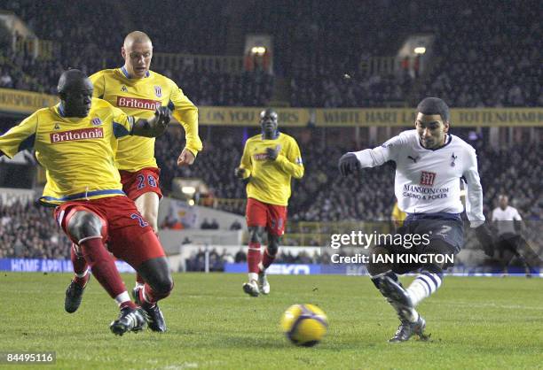 Tottenham Hotspurs Aaron Lennon scores his goal against Stoke City defended by Stoke City's Senegalese player Abdoulaye Diagne-Faye during their...