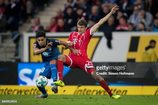 Nadiem Amiri of Hoffenheim is challenged by Thomas Mueller of Muenchen during the Bundesliga match between TSG 1899 Hoffenheim and FC Bayern Muenchen...