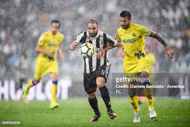 Gonzalo Higuain of Juventus and Alessandro Gamberini of Chievo Verona during the Serie A match between Juventus and AC Chievo Verona on September 9,...