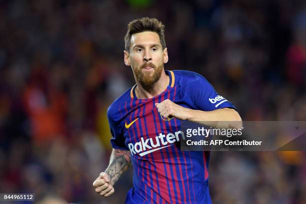 Barcelona's Argentinian forward Lionel Messi celebrates after scoring during the Spanish Liga football match Barcelona vs Espanyol at the Camp Nou...