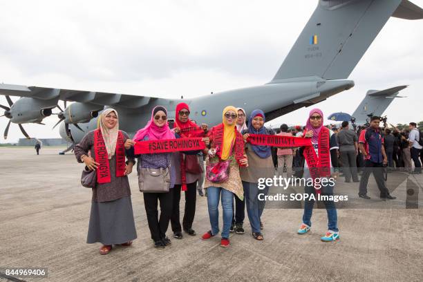 Supporters of a Malaysian humanitarian aid mission for the Rohingya population in Bangladesh participates at the departure ceremony of the mission at...