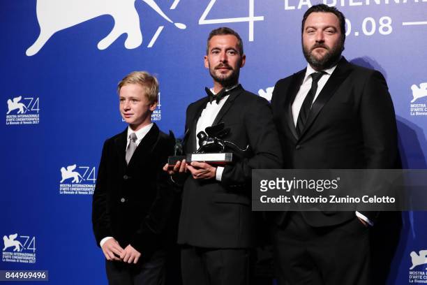Thomas Gioria, Xavier Legrand and Denis Menochet pose with the Silver Lion for Best Director Award for 'Jusqu'à la Garde' and the 'Luigi De...