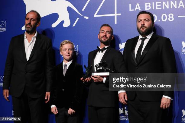 Alexandre Gavras, Thomas Gioria, Xavier Legrand and Denis Menochet pose with the Silver Lion for Best Director Award for 'Jusqu'à la Garde' and the...