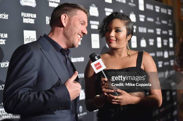 Alicia Quarles interviews a guest on the red carpet at Harper's BAZAAR Celebration of "ICONS By Carine Roitfeld" at The Plaza Hotel presented by...