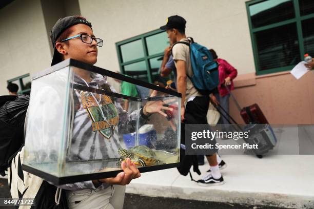 Samantha Casal arrives with her turtle Bubby at a shelter at Alico Arena where thousands of Floridians are hoping to ride out Hurricane Irma on...