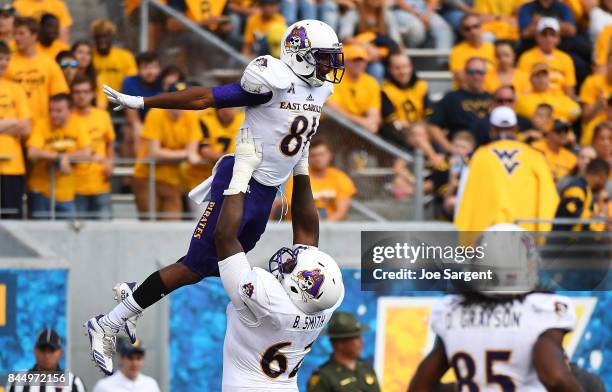 Jimmy Williams celebrates his touchdown with Brandon Smith of the East Carolina Pirates during the third quarter against the West Virginia...