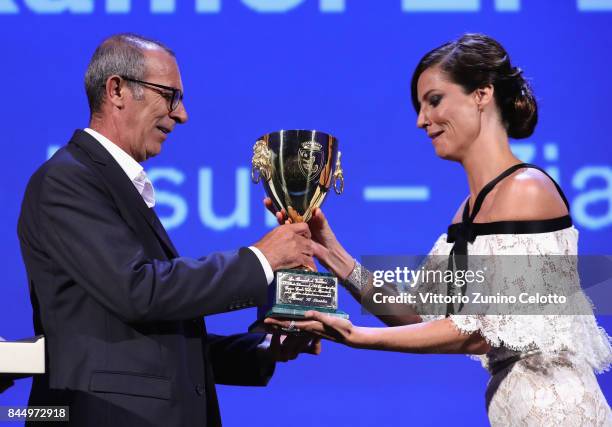 Kamel El Basha receives the Coppa Volpi for Best Actor Award for The Insult from 'Venezia 74' jury member Anna Mouglalis during the Award Ceremony of...