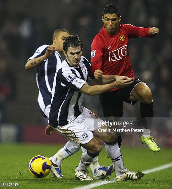 Cristiano Ronaldo of Manchester United clashes with Carl Hoefkens of West Bromwich Albion during the Barclays Premier League match between West...
