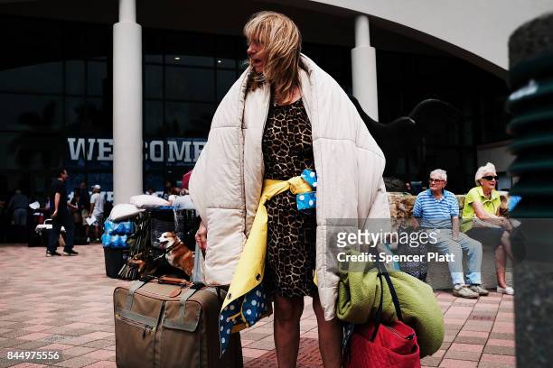 Woman arrives at a shelter at Alico Arena where thousands of Floridians are hoping to ride out Hurricane Irma on September 9, 2017 in Fort Myers,...