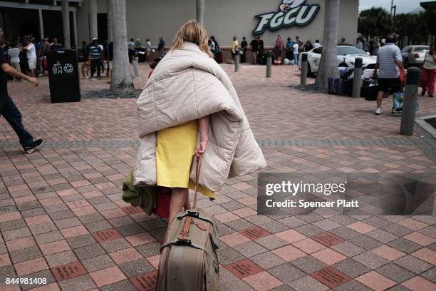 Woman arrives at a shelter at Alico Arena where thousands of Floridians are hoping to ride out Hurricane Irma on September 9, 2017 in Fort Myers,...