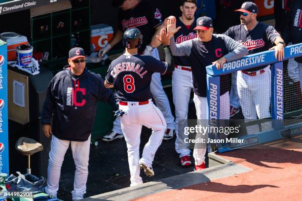 Manager Terry Francona and bench coach Brad Mills celebrate with Lonnie Chisenhall of the Cleveland Indians after Chisenhall scored during the fifth...