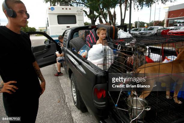 Having trouble finding a hotel room, members of the Watson family, of St. Petersburg, wait on the side of the road as they weigh their options on...