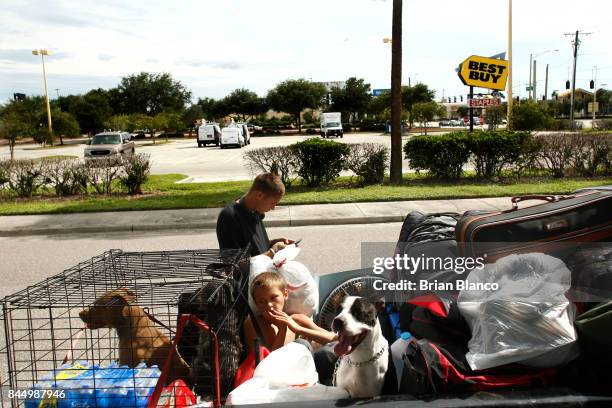 Having trouble finding a hotel room, members of the Watson family, of St. Petersburg, wait on the side of the road as they weigh their options on...