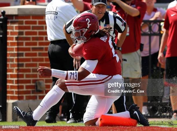 Jalen Hurts of the Alabama Crimson Tide scores a touchdown as he runs over the pylon against the Fresno State Bulldogs at Bryant-Denny Stadium on...