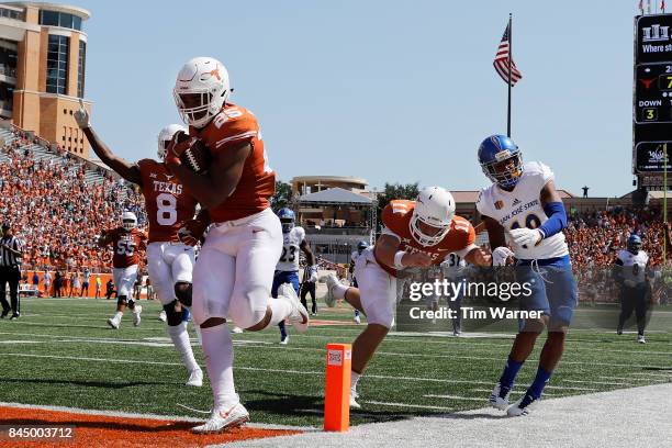 Chris Warren III of the Texas Longhorns rushes for a touchdown as Sam Ehlinger blocks Dakari Monroe of the San Jose State Spartans iin the second...